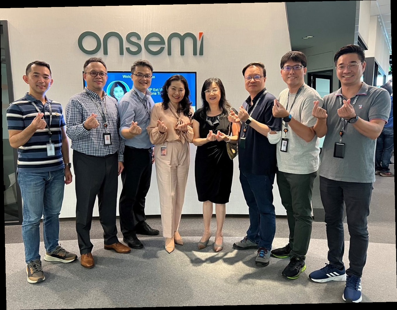 Six onsemi employees standing by a sign that says #weareonsemi.